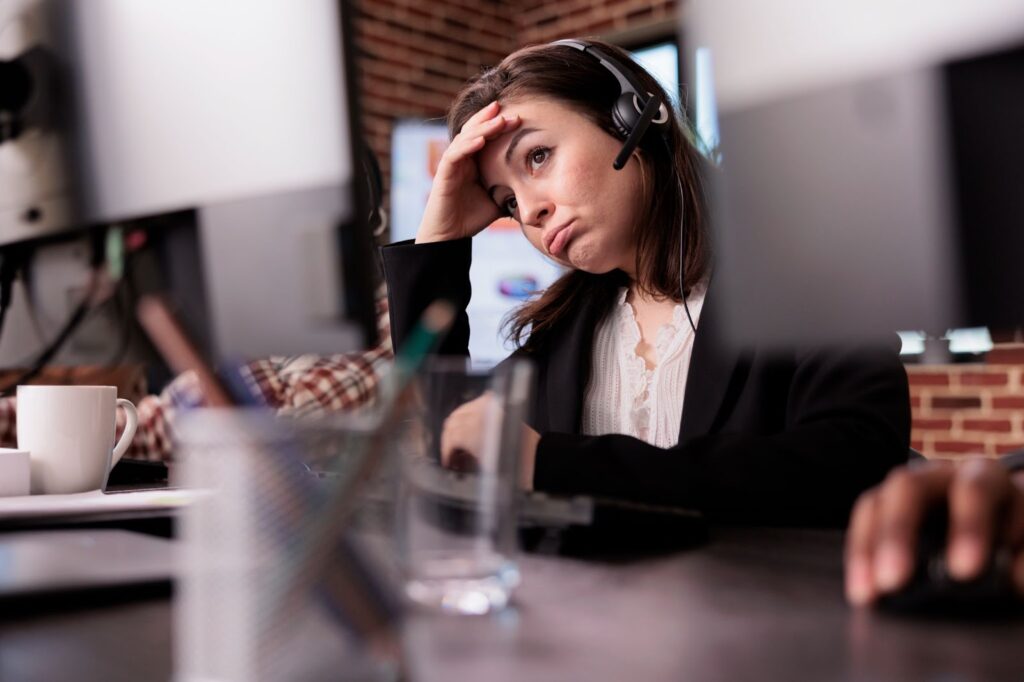Woman feeling tired at customer support job