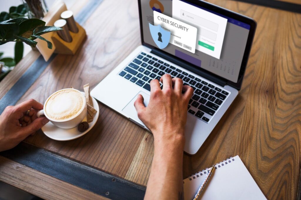 Top view of man working on laptop with cyber security